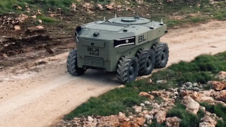 BLR MK2 autonomous ground robot with eight large off-road wheels on a dirt road in rocky outdoor terrain